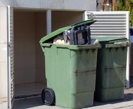 Inspector auditing safety practices in waste removal operations